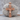 Saint Benedict Crucifix Pendant, rose gold, product photo on stone base