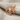 Anatolian Double Headed Eagle Earring, rose gold, angled view on linen
