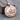 Life Is Beautiful Coin Pendant, rose gold plated, front view on wood