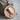 Nefertiti Medallion Pendant, rose gold, front view on wood block