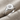 Star Set Signet Ring, polished silver, angled view on fabric