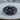 Helmet Winged Skull Ring, black rhodium, front product view on wood