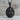 Saint Peter Apostle Relief Pendant, black rhodium plated, front view on wood