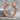 Wolf Hoop Earring, rose gold, front view on stone surface