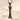 Bird letter I pendant in black rhodium plated silver, front view resting on sand