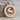 Taurus Zodiac Wheel Pendant, rose gold, front view on wood block