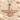 Ahura Mazda Faravahar Pendant, rose gold, resting on sand with seashells