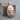 Primate Head Pendant, rose gold plated silver, angled view on wood block