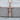 Celtic Dagger Pendant, rose gold finish, front view on wood base