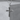 Black Cross Pendant, polished, front view on stone pedestal