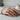 Japanese snake chrysanthemum ring, oxidized, worn on model hand on stone table