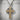 Celtic cross woven pendant, two-tone finish, studio product photo