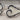Ivory Scroll Collar Ring, oxidized, close-up of scroll terminals and enamel