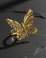 Gold vermeil butterfly ring with half floral and half abstract wing design on black stone