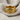 Close-up of the 14K gold vermeil Taurus zodiac ring elegantly displayed on a soft textured beige linen fabric.