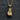 Detailed close-up of a gold vermeil boxing glove pendant showing intricate laces resting on dark grey felt