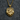 Close-up of detailed 925 sterling silver bear paw pendant with gold vermeil finish resting on dark grey textured fabric