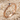 Dainty Snake Ring, rose gold, angled product photo on sand