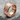 Ancient Artifact Ring, rose gold, angled view on stone base