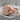 Melted Signet Ring, rose gold plated silver, angled view on textured pedestal