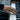 Hand wearing a modern multi hoop statement ring while playing piano keys in an elegant lifestyle setting