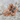 Floral Cross Ring in rose gold finish, angled product photo on stone