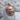 Snarling Cat Medallion Pendant, rose gold plated silver, angled view on stone