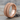 Biomechanical Gear Band Ring in rose plated silver, angled view on wood background