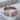 Molten droplet open ring, rose gold, front view on stone display