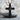 Military cross pendant, black rhodium, front view on stone pedestal