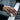 Close-up view of skeletal hand telekinesis ring with dark stone featured on a finger playing piano keys