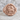 Agnus Dei ring, rose gold, front view on stone surface