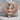 Winged Bastet Pendant, rose gold, front view resting on stone