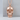 Human Skull Pendant, rose gold, front view on display pedestal