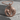 Lioness and cub medallion pendant, rose gold finish, front view on concrete block