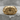 War Signet Ring, gold vermeil, front view on stone surface