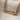 Horizontal Safety Pin Pendant, rose gold, laying on fabric
