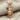 Eagle Wolf Totem Pendant, rose plated silver, front view on textured fabric