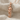 Dancing Couple Pendant, rose gold plated, front view on fabric