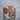 Maltese Cross Skull Ring, rose gold, angled product photo on wet stone