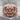Japanese Oni Demon Ring, rose gold, front view on stone pedestal