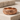 Rose Thorn Ring, black rhodium, front view on textured rock
