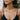 Model wearing dainty gold boo script necklace floating centered at collarbone for chic everyday layering
