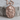 Grim reaper rose pendant in rose gold finish, angled view on wood
