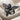 Praying Cherub Ring, black rhodium, angled front view on fabric
