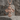 Praying Virgin Mary Cross Pendant, rose gold, front view on stone