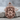 Holy Face Jesus Pendant, rose gold, front view resting on stone