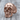 Anatomical skull jaw ring, rose gold, three-quarter view on wood