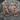 Comedy Tragedy Earring, rose gold, pair displayed on stone surface