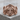 Praying hands cross ring in rose gold, front view on wood
